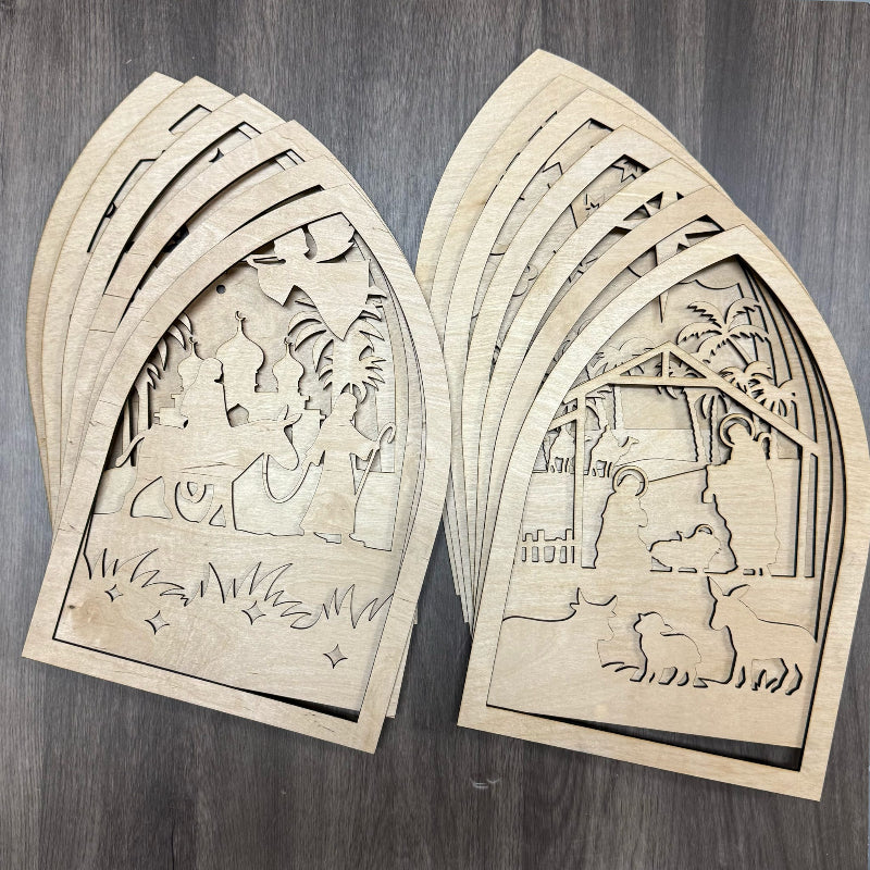 Two wooden cut-out panels with architectural designs on a wooden surface