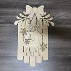 Wooden decorative panel with reindeer, snowflakes, and bow on a wooden background