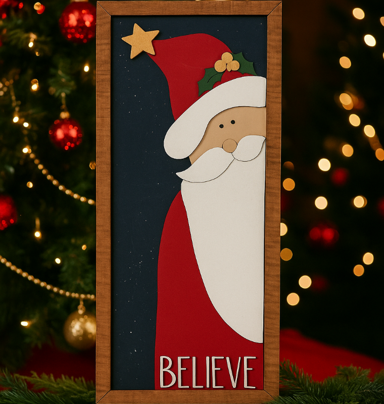 Framed artwork of a Santa Claus face with 'BELIEVE' text, Christmas tree and lights in the background.