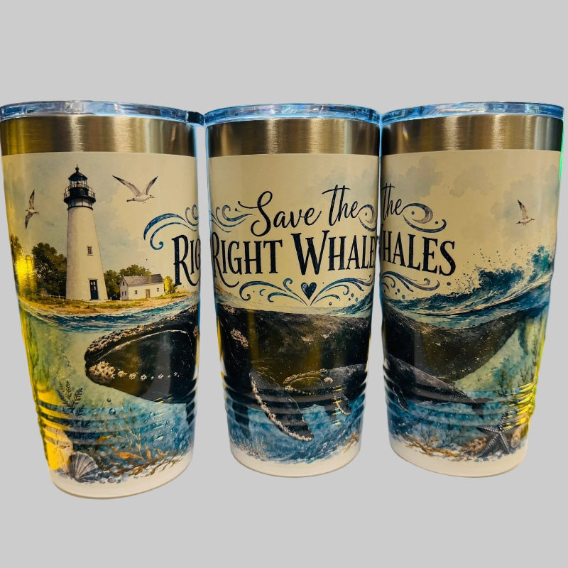 Three tumblers with ocean-themed designs on a desk.