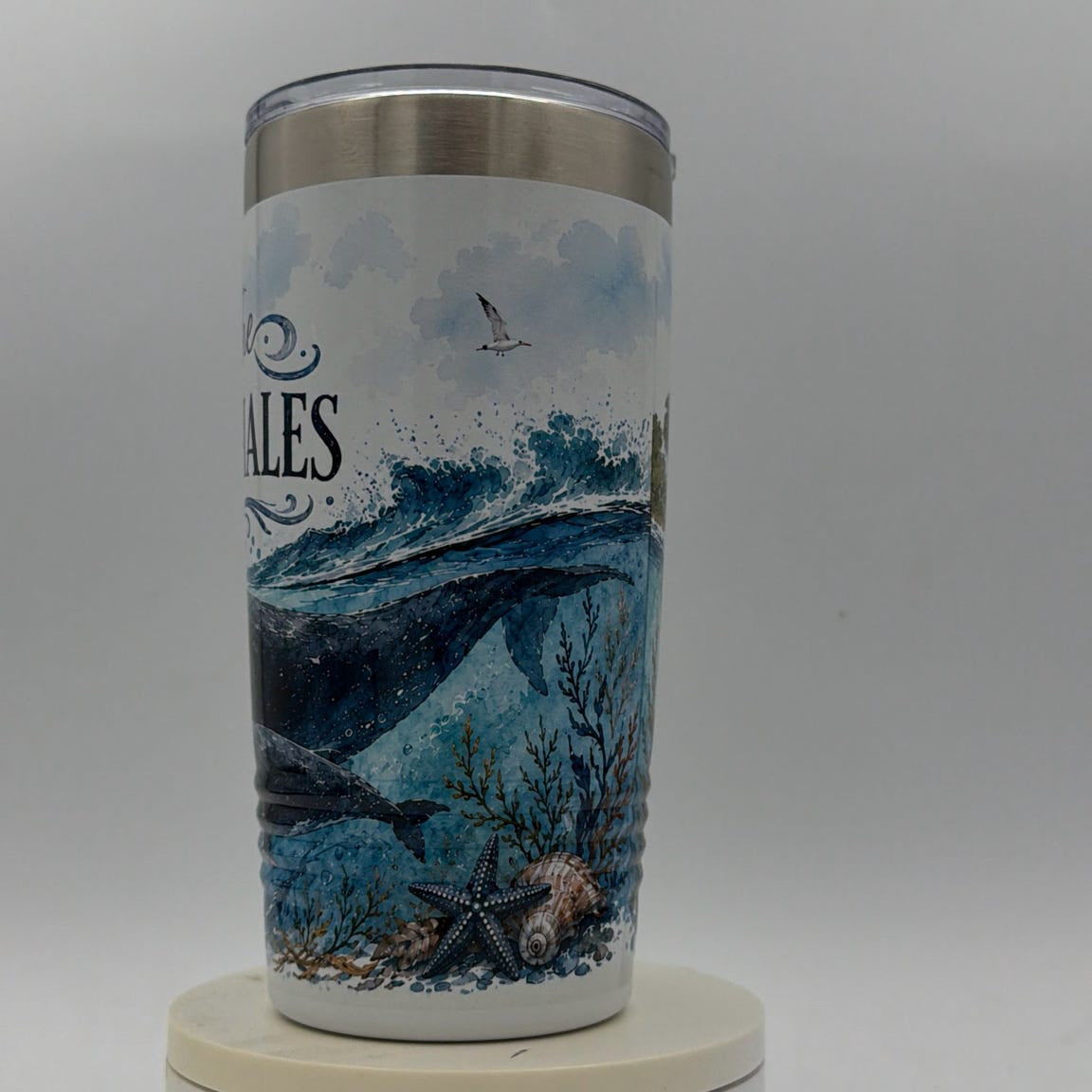 Tumbler with whale design on a white background