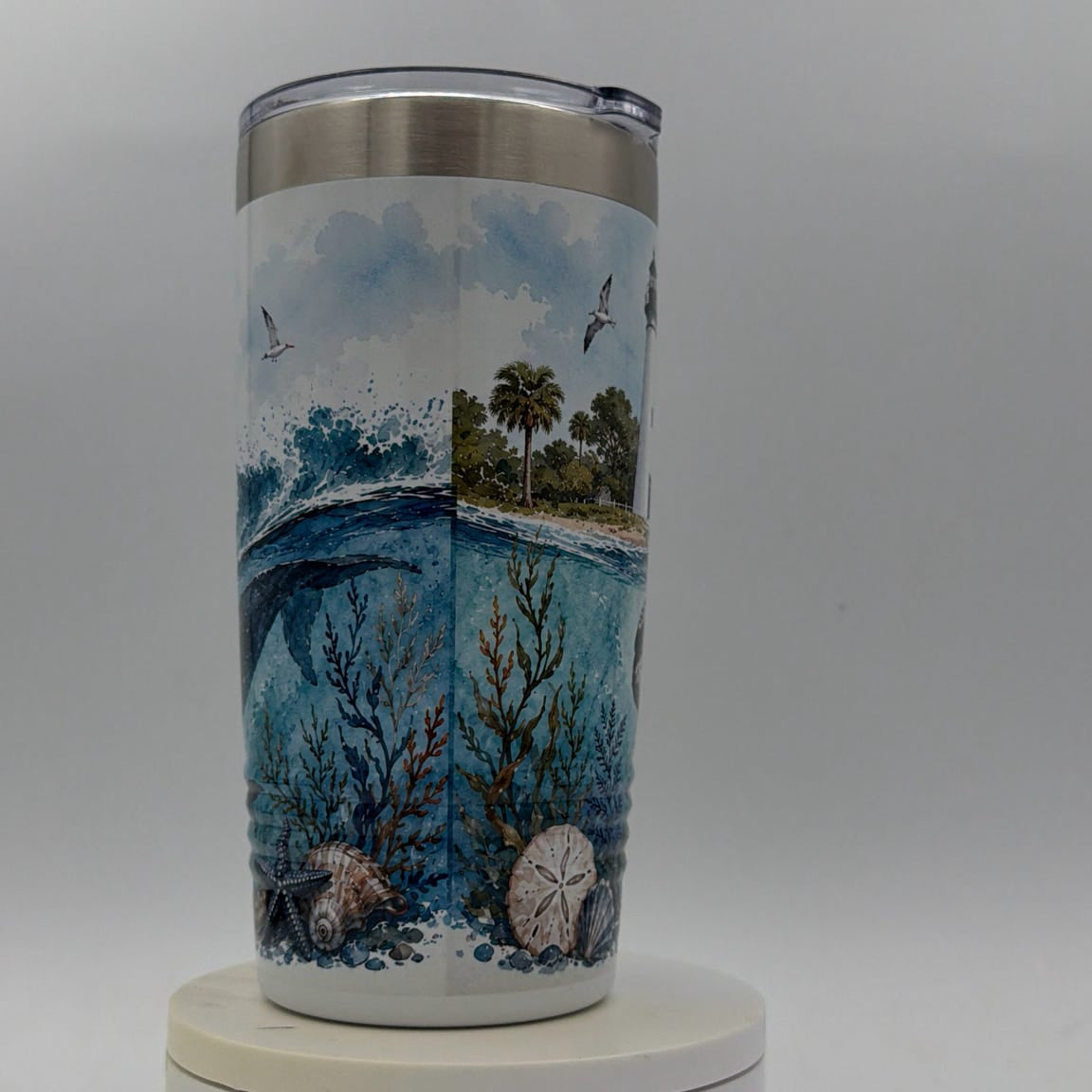 Tumbler with a beach scene design on a white background