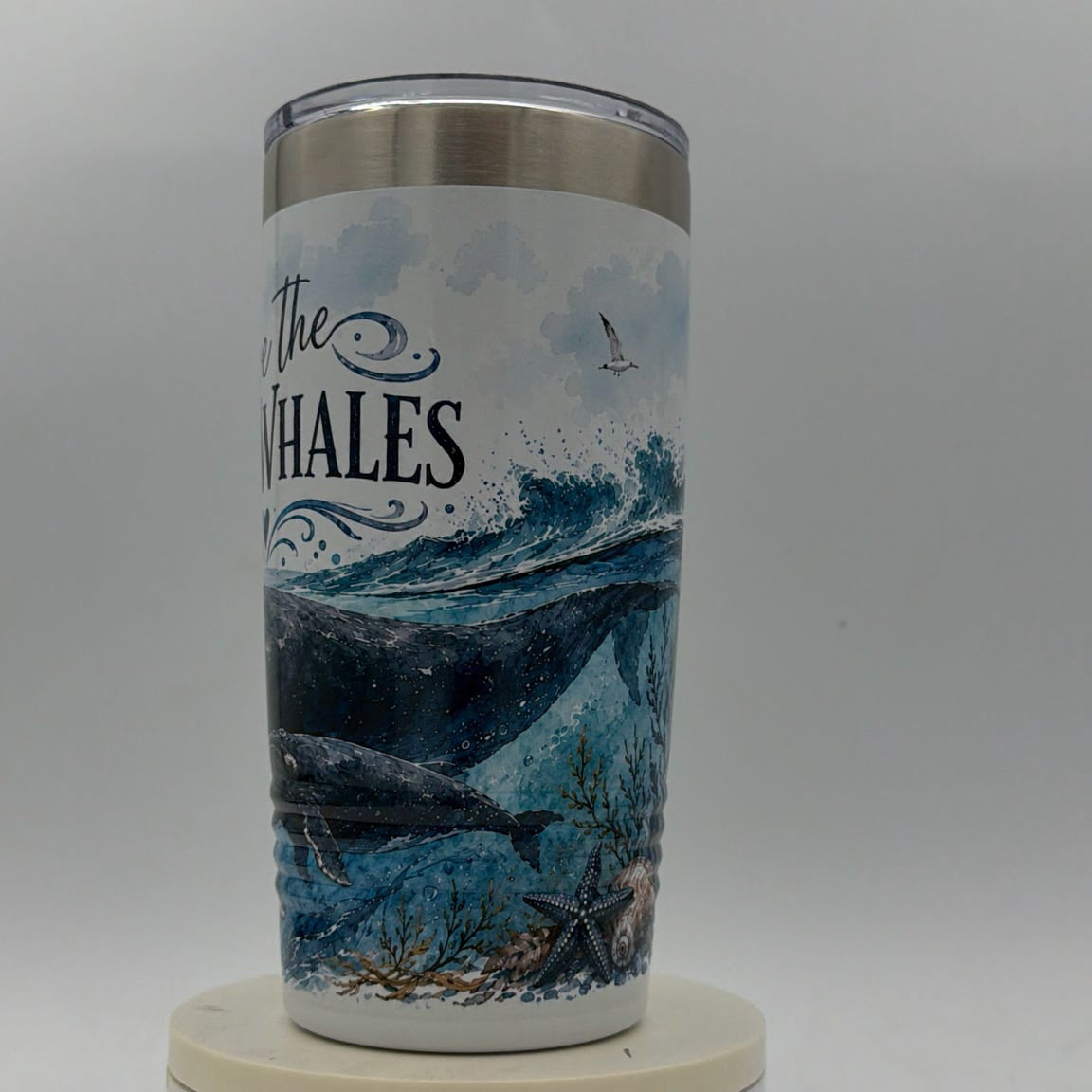 Tumbler with whale design and 'The Whales' text on a white background