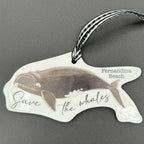 Whale-shaped sticker with 'Save the Whales' text on a gray background