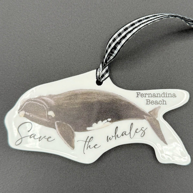 Whale-shaped sticker with 'Save the Whales' text on a gray background