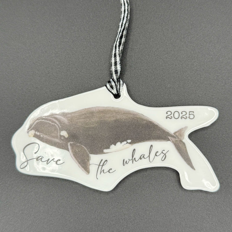 Whale-shaped ornament with 'Save the Whales' text on a gray background