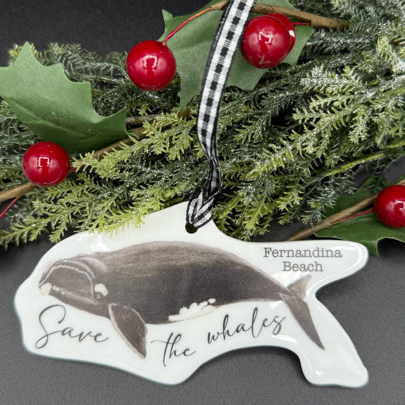 Ornament shaped like a whale with 'Save the Whales' text, surrounded by greenery and berries.