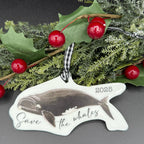 Decorative ornament with whale design and 'Save the Whales' text, placed on a festive background.