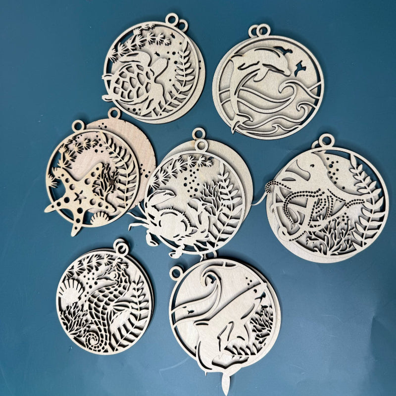 Set of silver animal-themed pendants on a blue background