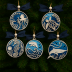 Set of five decorative ornaments with marine life designs on a dark green background.