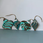 Set of decorative ornaments with turquoise and brown patterns on a white and gray background