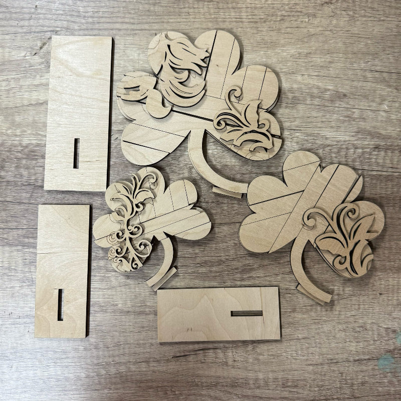 Wooden decorative pieces with floral patterns on a wooden surface