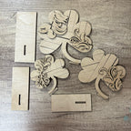 Wooden decorative pieces with floral patterns on a wooden surface