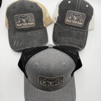 Three trucker-style baseball caps displayed on a white background, each with a rectangular front patch reading Shark Tooth Hunter. The top two caps have dark gray washed fronts with beige and off-white mesh back panels, while the bottom cap has a heather gray front with black mesh back panels.