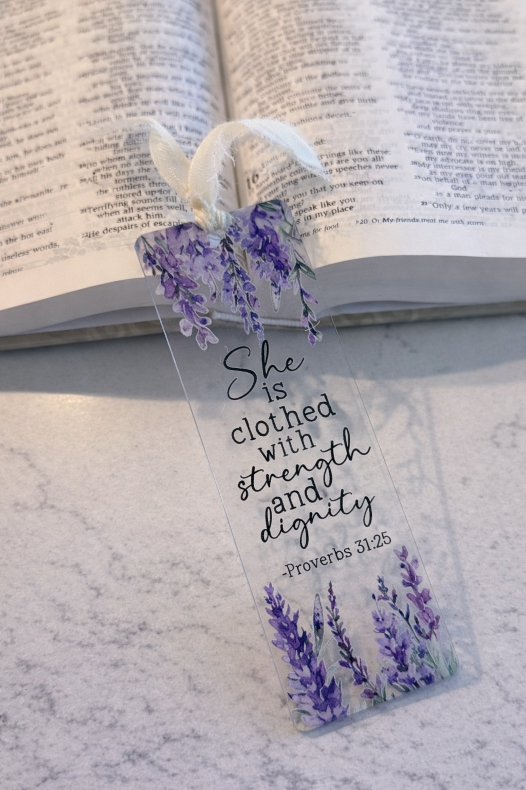 Decorative bookmark with lavender design and text on an open book