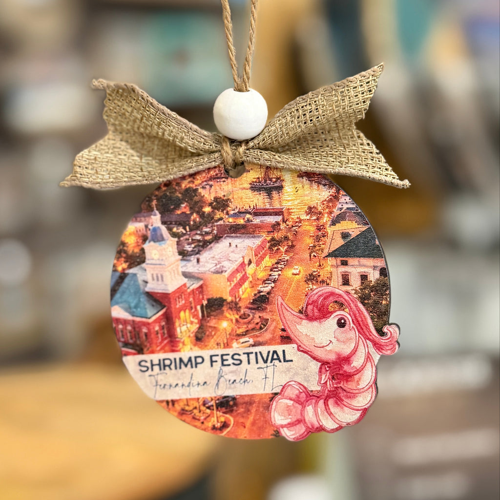 Decorative ornament with a shrimp festival design and burlap bow on a blurred background