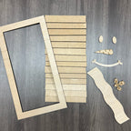 Wooden frame pieces and decorative elements on a wooden surface
