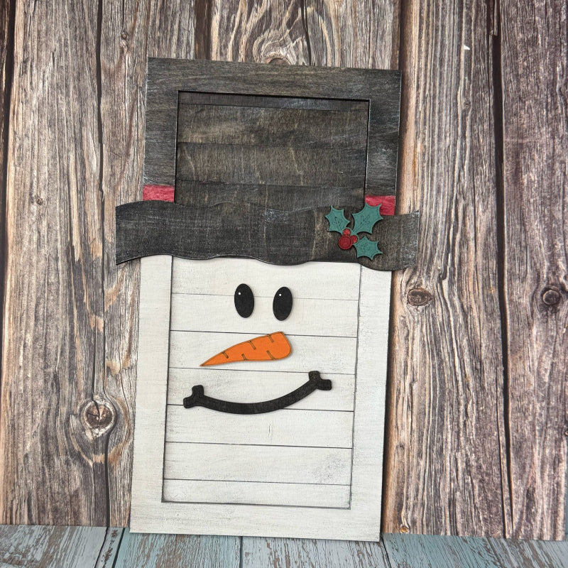 Wooden snowman decoration on a rustic wooden background
