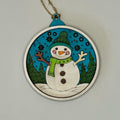 Decorative ornament with a snowman design on a plain background