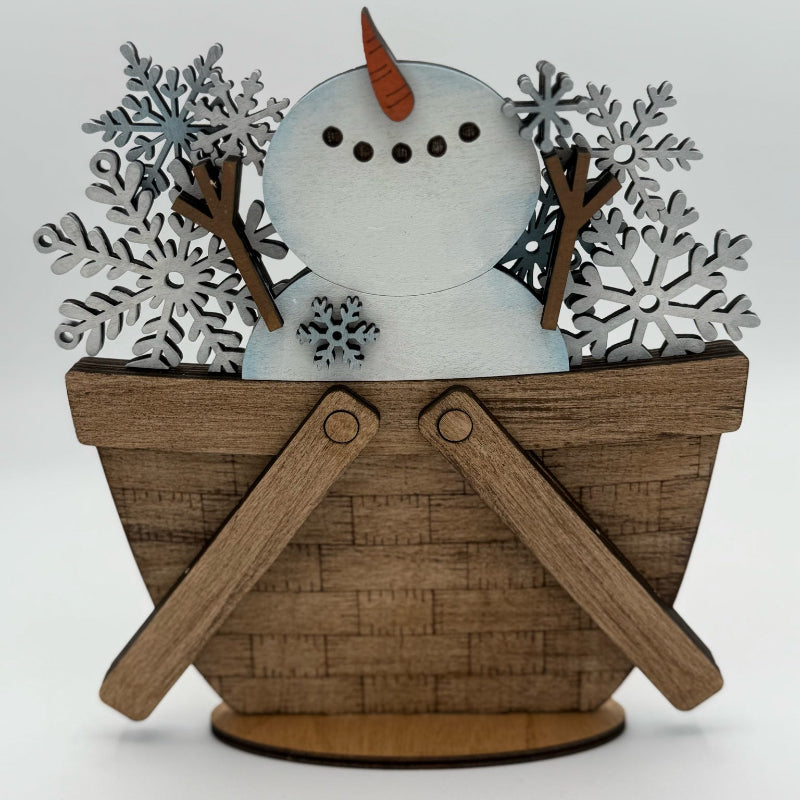 Decorative snowman figurine with wooden basket and snowflakes on a white background