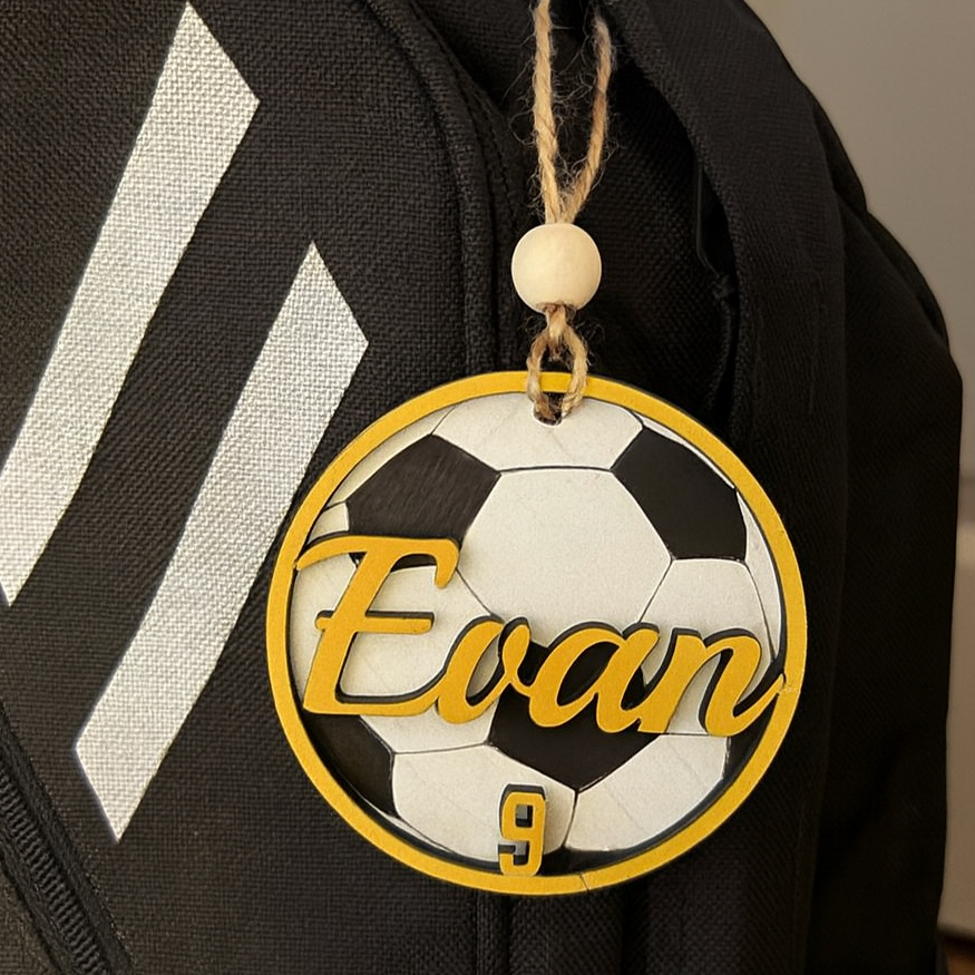 Backpack with a soccer-themed name tag reading 'Personalized Name' on a plain background