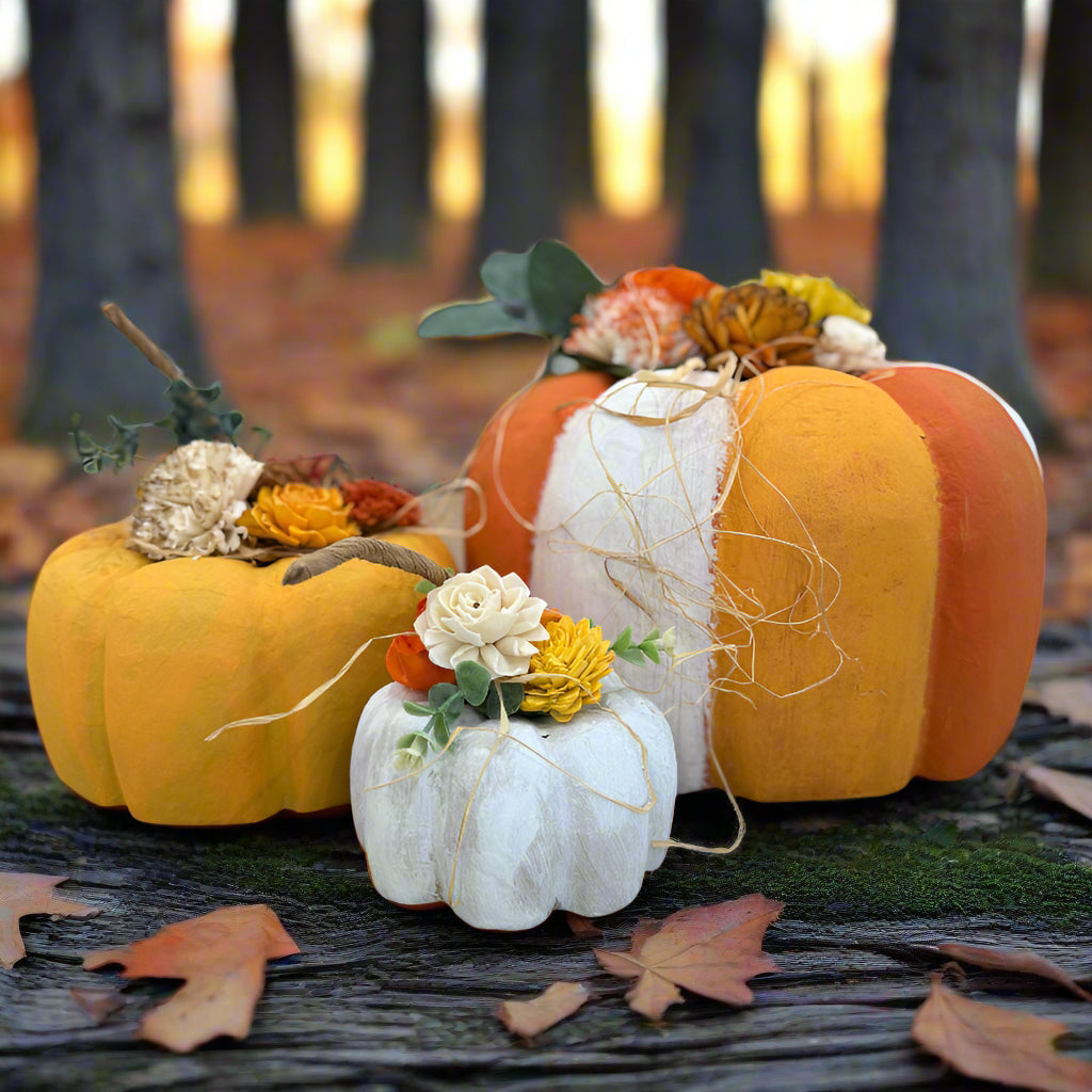 Decorative pumpkins with flowers on a table in a store setting