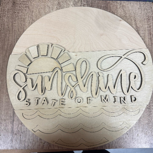 Wooden round sign with 'Sunshine State of Mind' engraving on a wooden surface