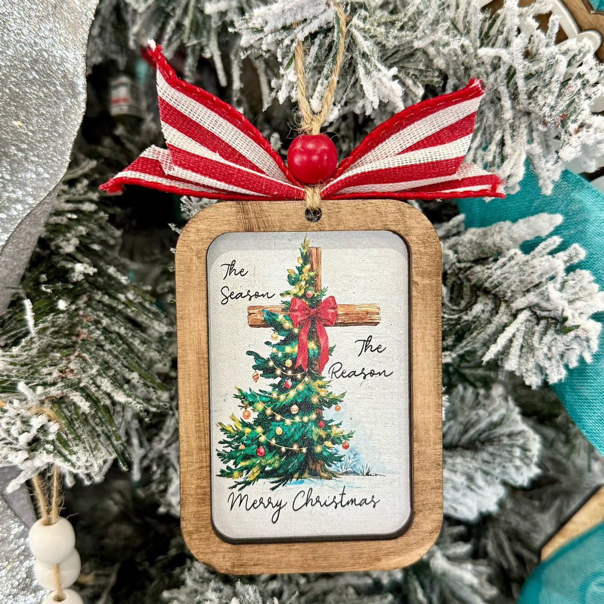 Christmas ornament with a wooden frame and festive design on a Christmas tree. The Reason for the Season.