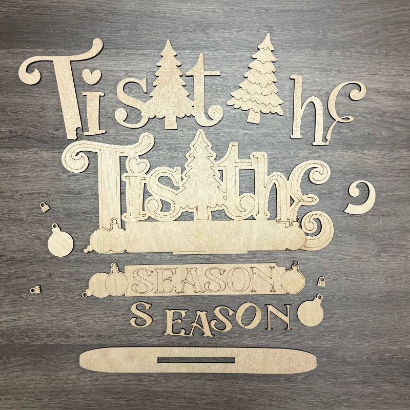Wooden Christmas decoration with 'Tis the Season' text on a wooden background
