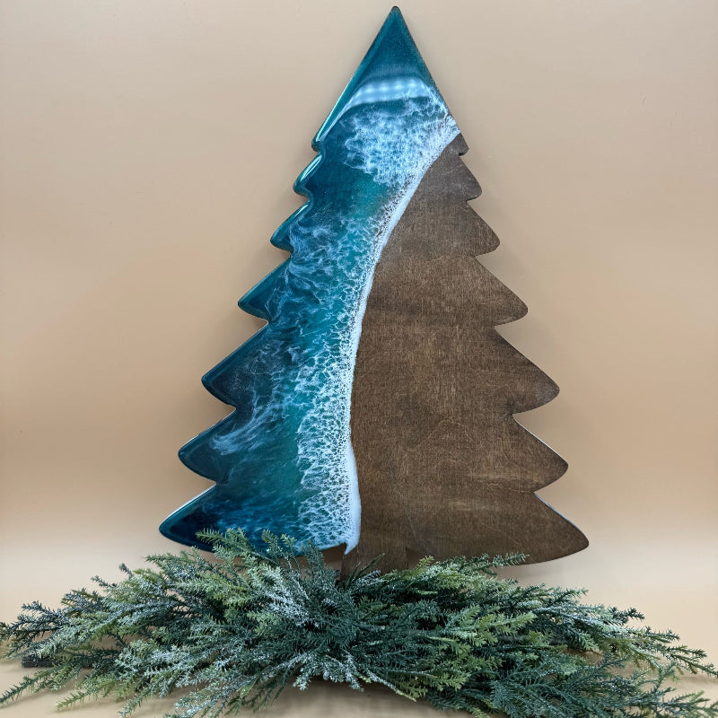 Decorative wall art of a stylized tree with blue and brown colors, placed on a beige background.