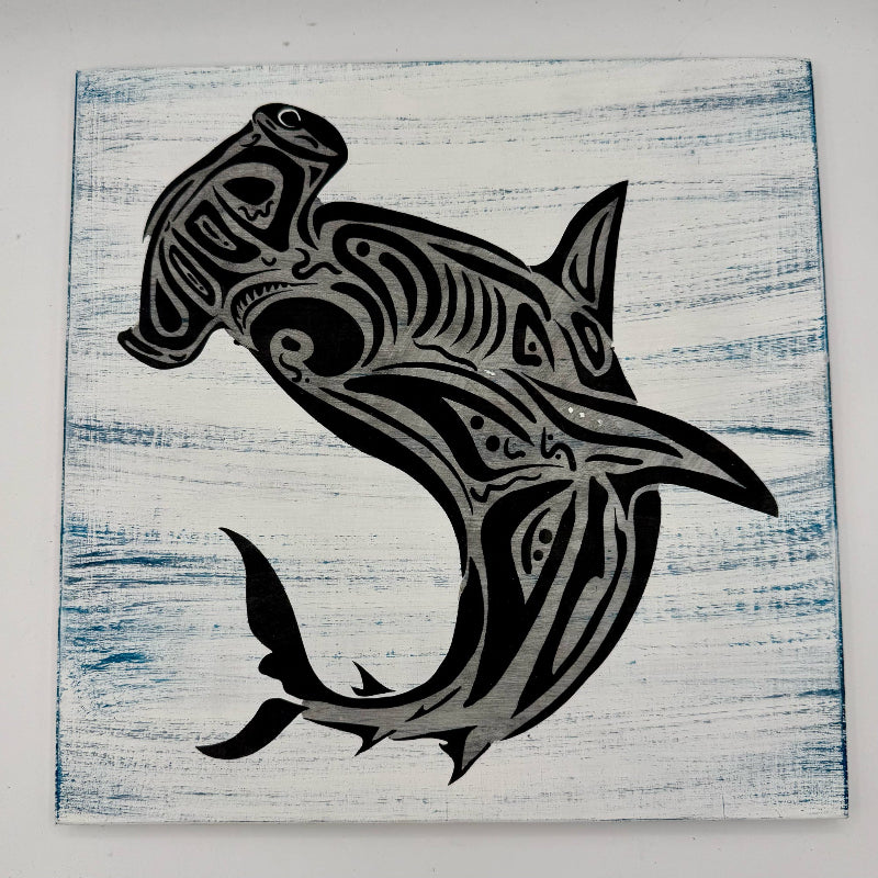 Black tribal shark design on a textured white and blue background