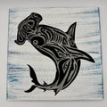 Black tribal shark design on a textured white and blue background