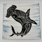 Black tribal shark design on a textured white and blue background