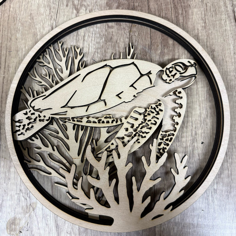 Wooden cutout of a turtle and coral on a wooden background