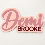 Close-up of a layered 3D wood name sign with script first name and block middle name