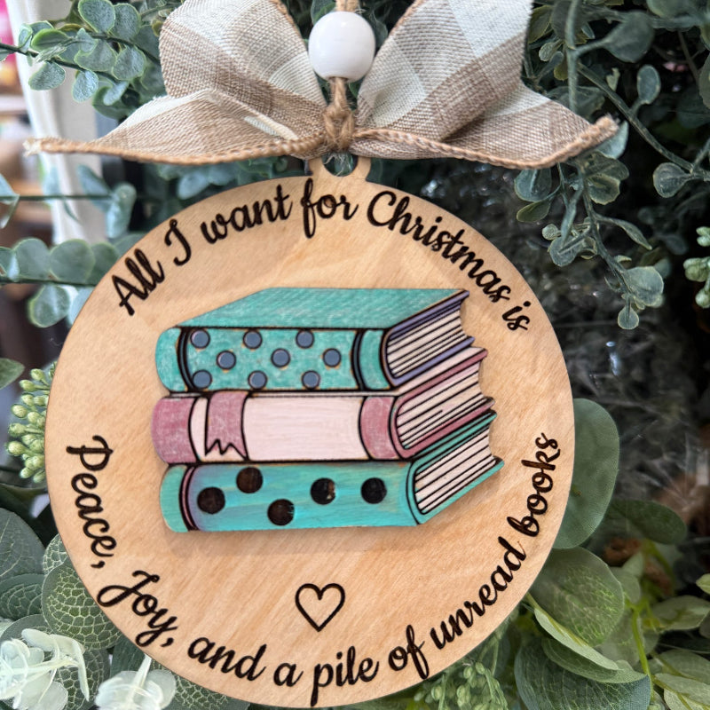Wooden ornament with books design and text on a green leaf background