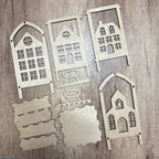 Set of wooden house-shaped cutouts on a wooden surface