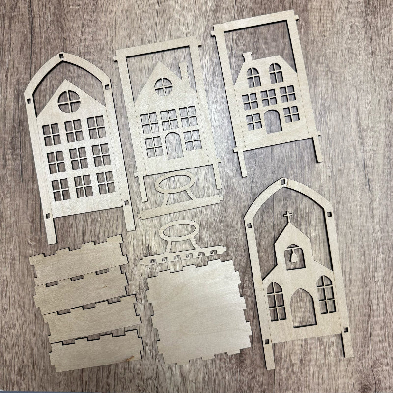 Set of wooden house-shaped cutouts on a wooden surface