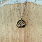 Necklace with a circular pendant on a wooden surface