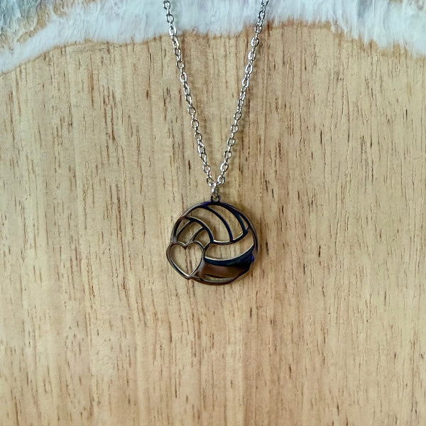 Necklace with a circular pendant on a wooden surface