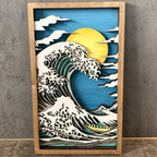Wooden framed artwork of a wave and sun on a gray wall