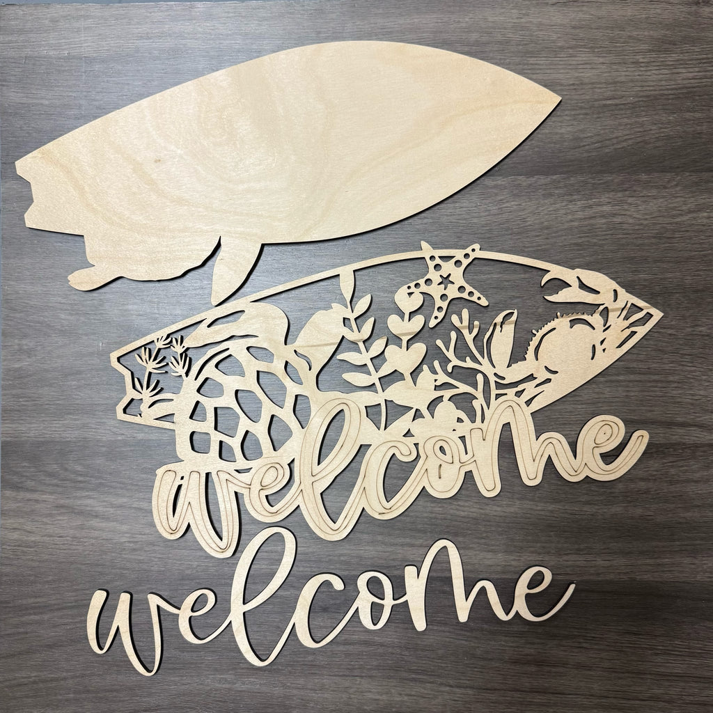 Wooden fish-shaped sign with 'welcome' text on a wooden surface
