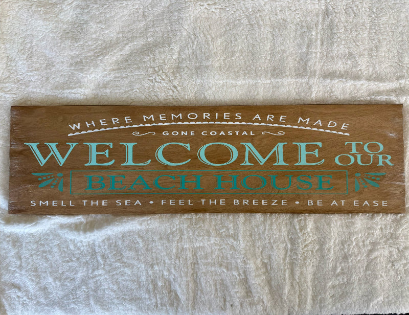 Wooden sign with decorative text on a textured white background