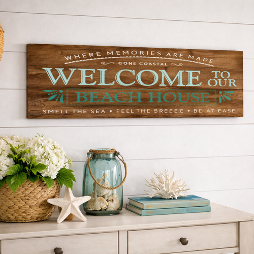 Decorative sign with 'Welcome to our Beach House' text in a coastal-themed room.
