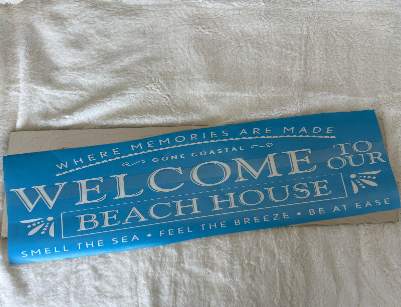 Blue and white sign with text on a textured surface