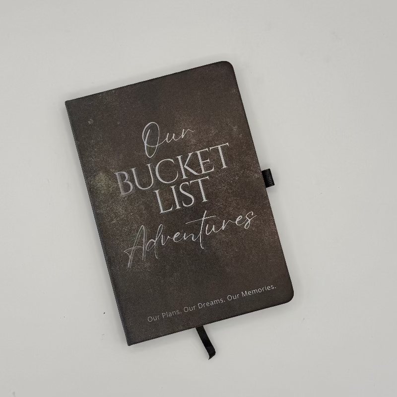 Journal titled 'Our Bucket List Adventures' on a light gray background