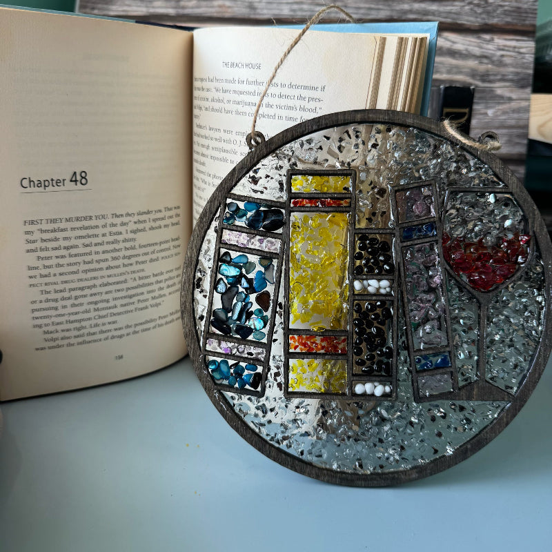 Decorative circular object with mosaic design on an open book