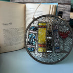 Decorative circular object with mosaic design on an open book