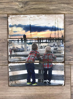 Two little boys at a marina at sunset photo on a three plank wood photo block