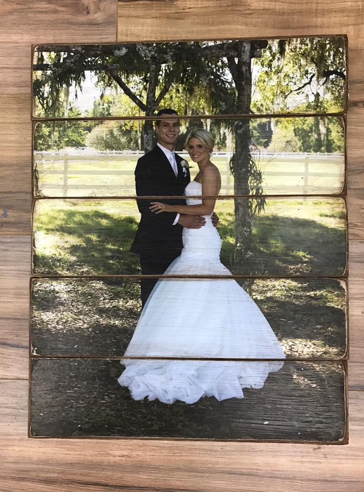 Bride and groom under a tree photo on a vertical five plank wood photo pallet